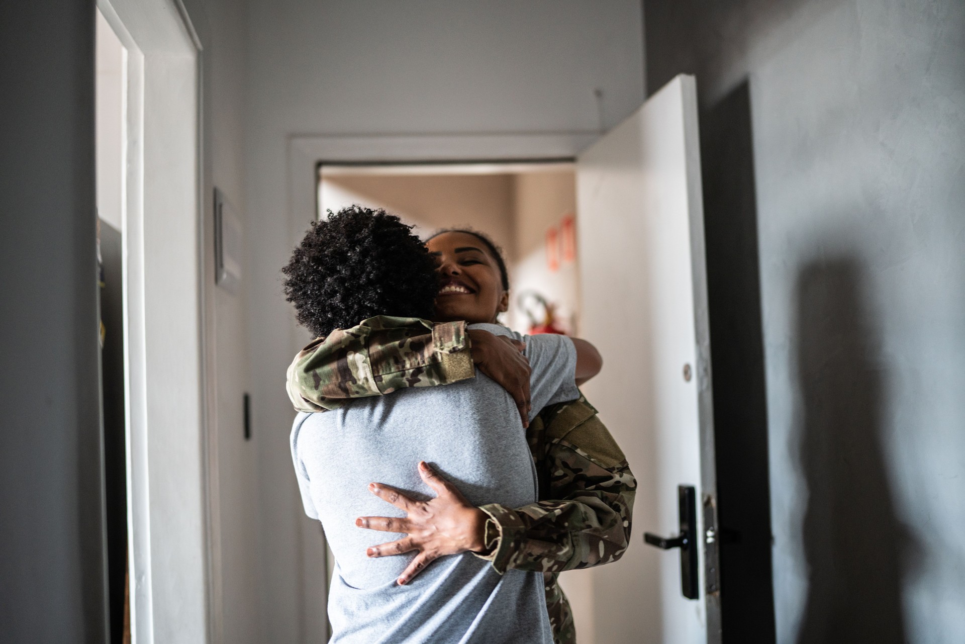 Son welcoming soldier mother at home